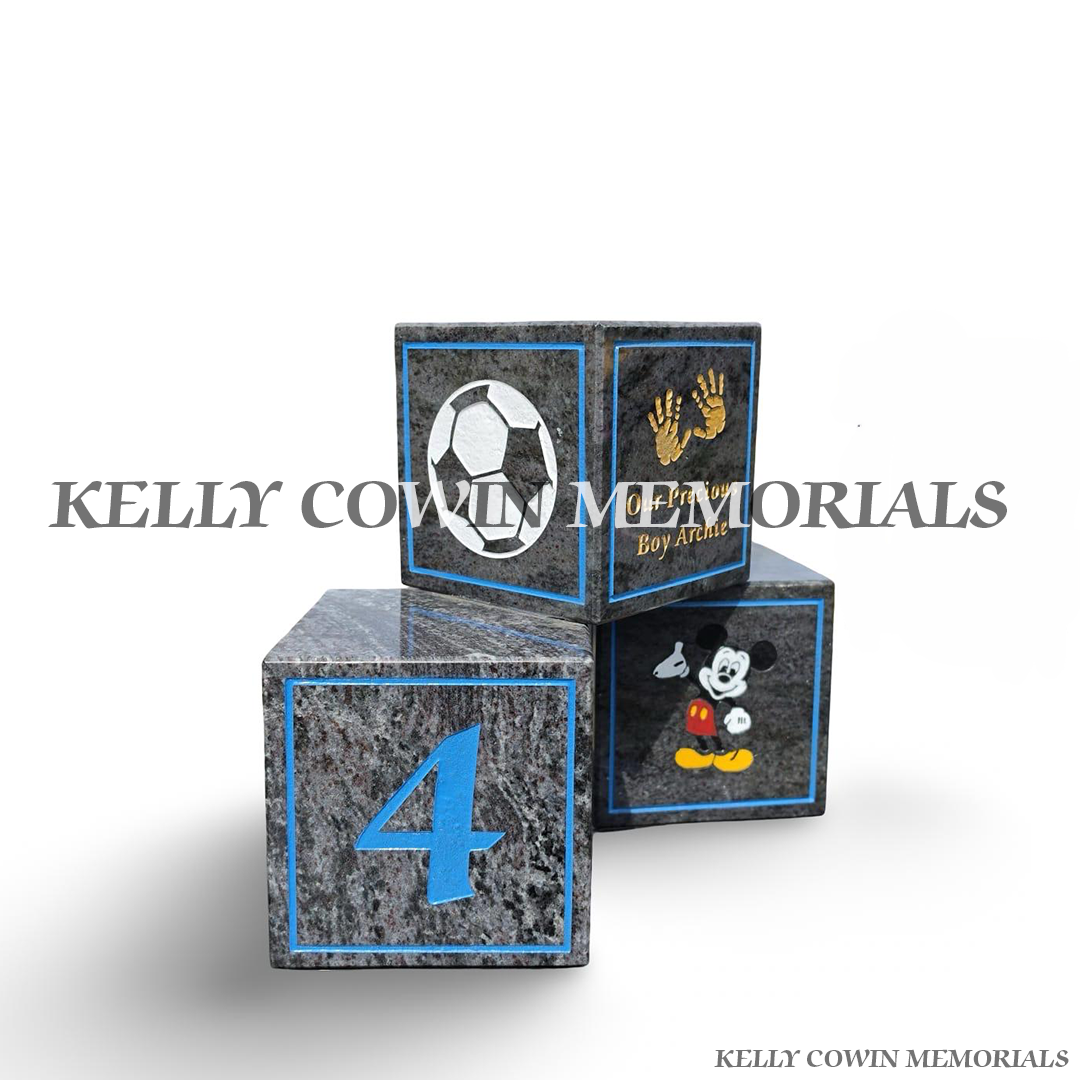 left side of Personalised Blue Lagoon granite baby memorial blocks with coloured engraved wording, numbers, handprints and child-themed memorial images by Kelly Cowin Memorials