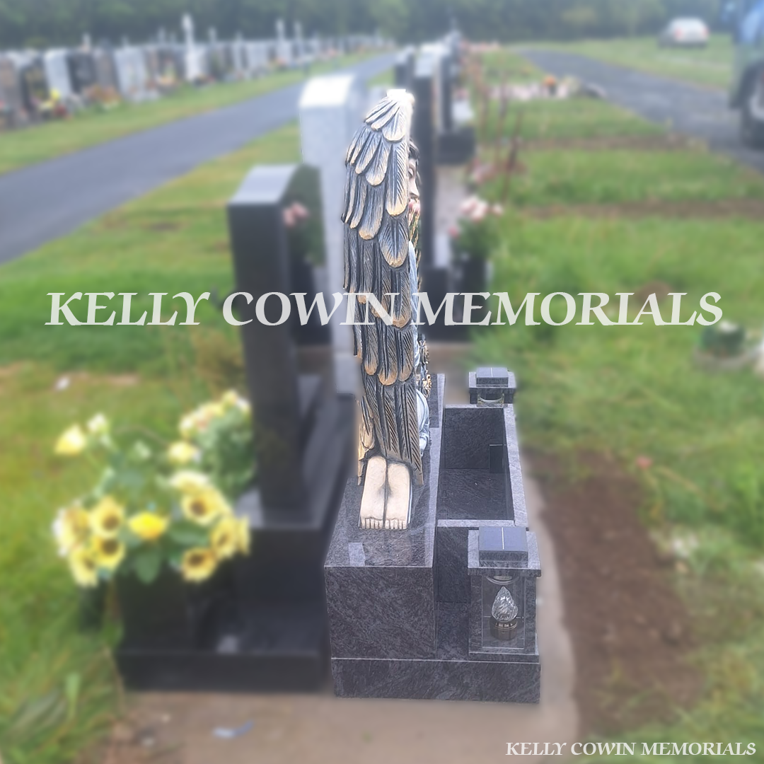 Side view of Blue Lagoon memorial with carved rose detail and solar lanterns
