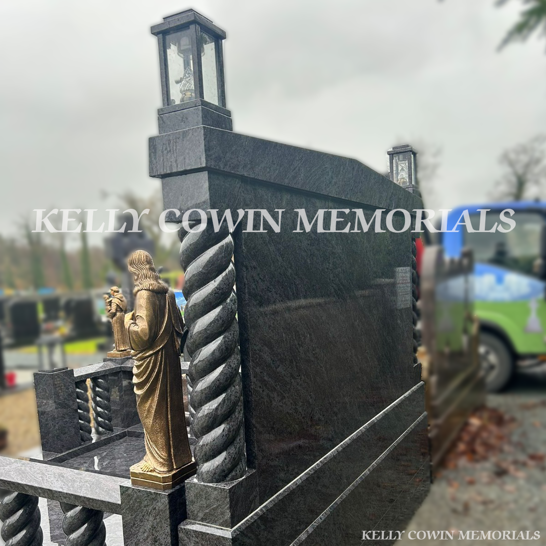 Blue Lagoon granite book headstone with twisted pillars, bronze religious statues and gold leaf inscription in Mount Bellew Cemetery, Galway