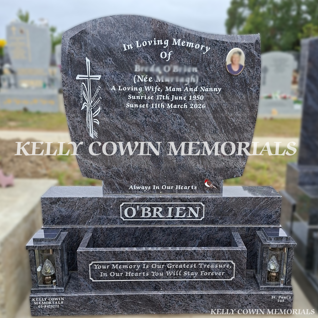 Blue C1 granite headstone with sub base, base, plinth, two solar lanterns, flower box, ceramic memorial photo and silver inscription installed in Balgriffin Cemetery, Dublin by Kelly Cowin Memorials.