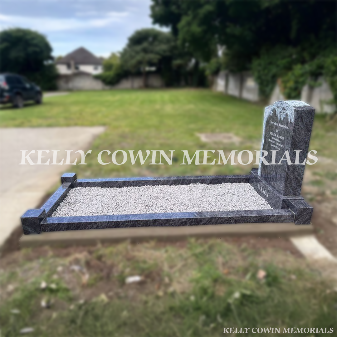 Side view of hand-carved tree memorial headstone in Blue Lagoon granite with kerbing and grey chippings at Esker Cemetery”