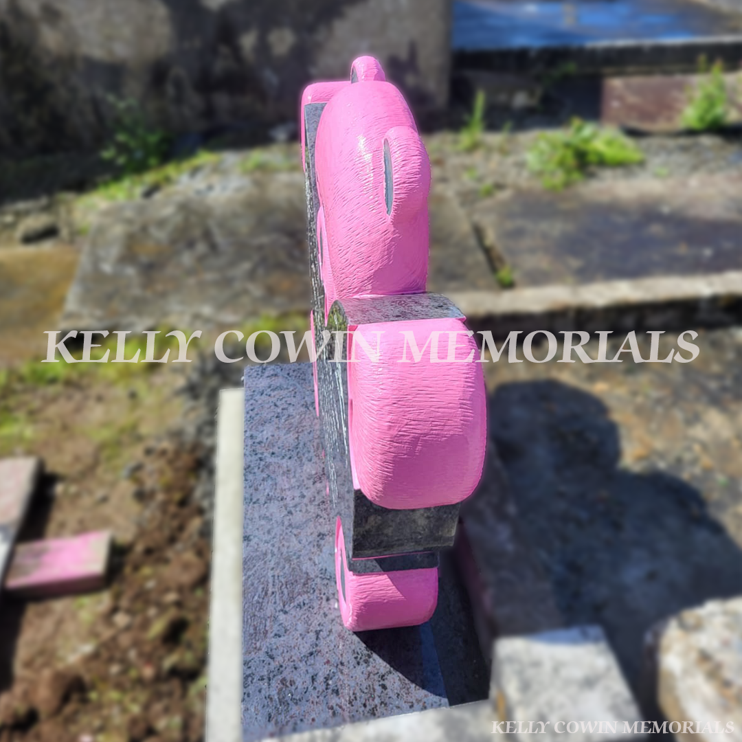 “Side view of Blue Lagoon granite teddy bear child memorial headstone on plinth in County Clare”