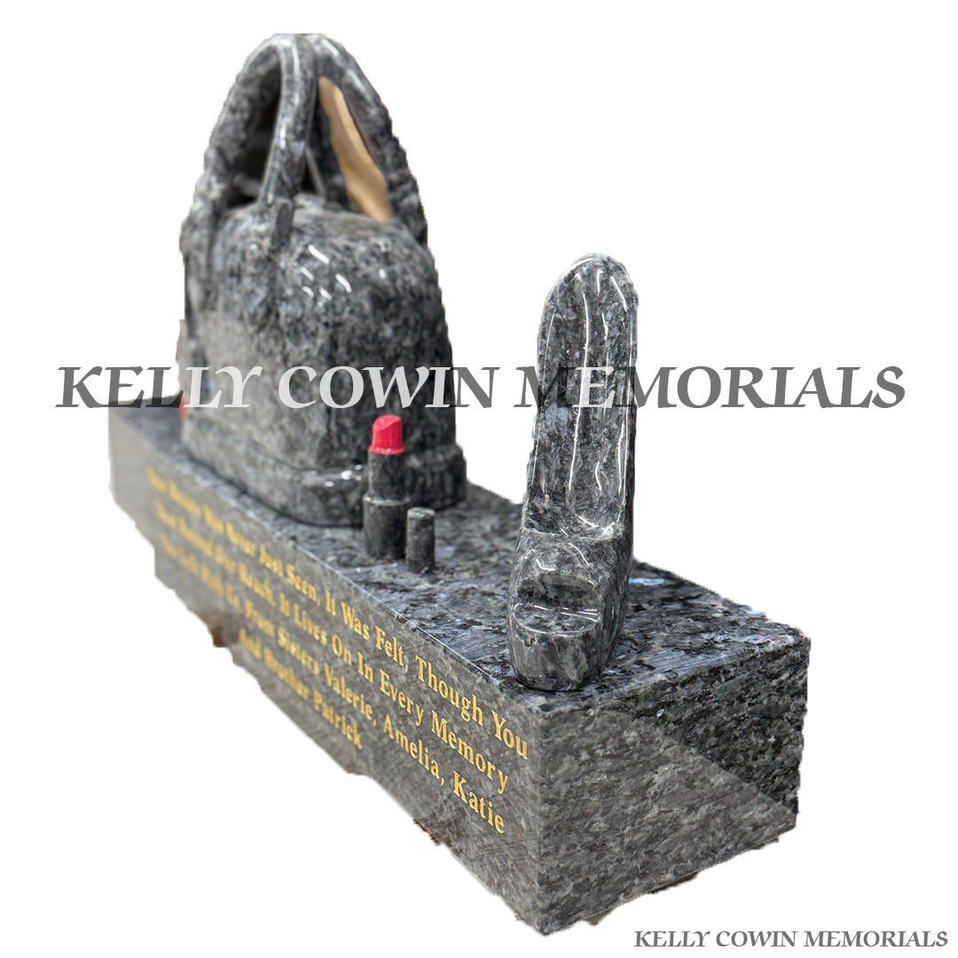 Side view of custom Blue Pearl granite accessories on engraved plinth