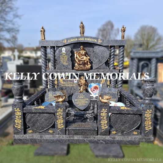 Front view of Blue Lagoon broken heart headstone with gold leaf inscription and bronze statues