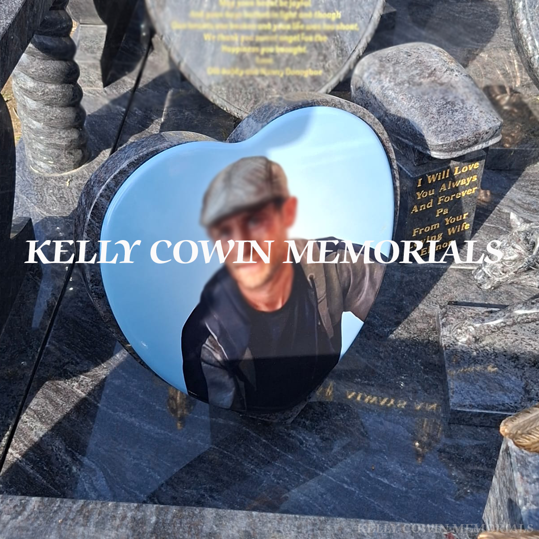 Close-up of gold leaf inscription and detailed statues on Blue Lagoon headstone