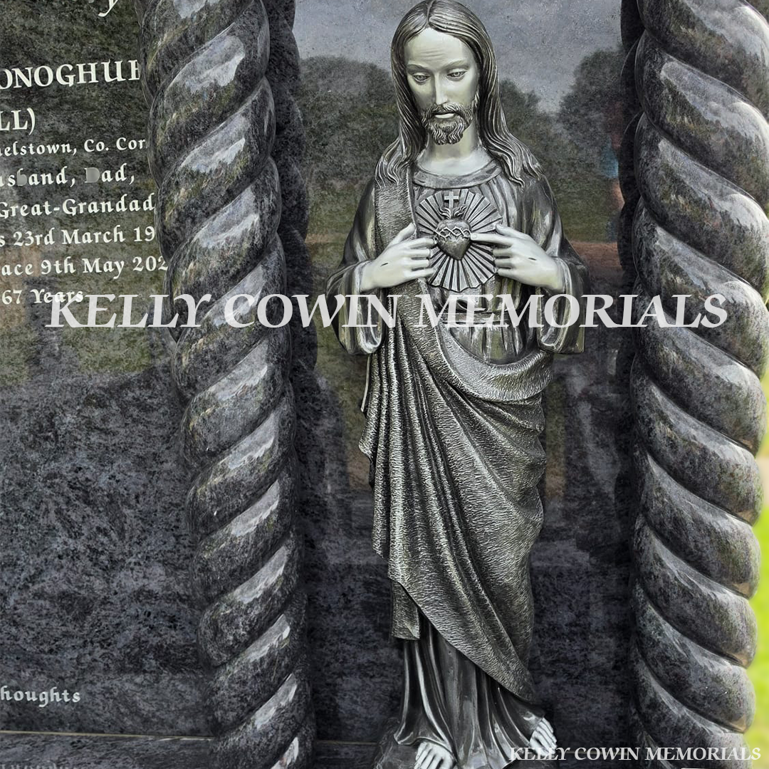 Close-up of large silver our lord statue on Blue Lagoon headstone