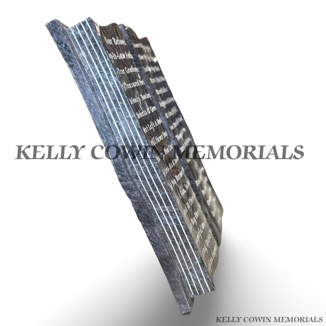 Side profile of large Blue Lagoon granite Bible memorial showing carved page detailing and polished granite finish.