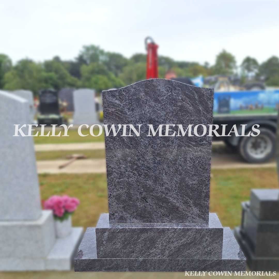 Back view of Blue Lagoon OG granite headstone with silver inscription, oval ceramic photograph, praying hands engraving, base and plinth in Balgriffin Cemetery Dublin.