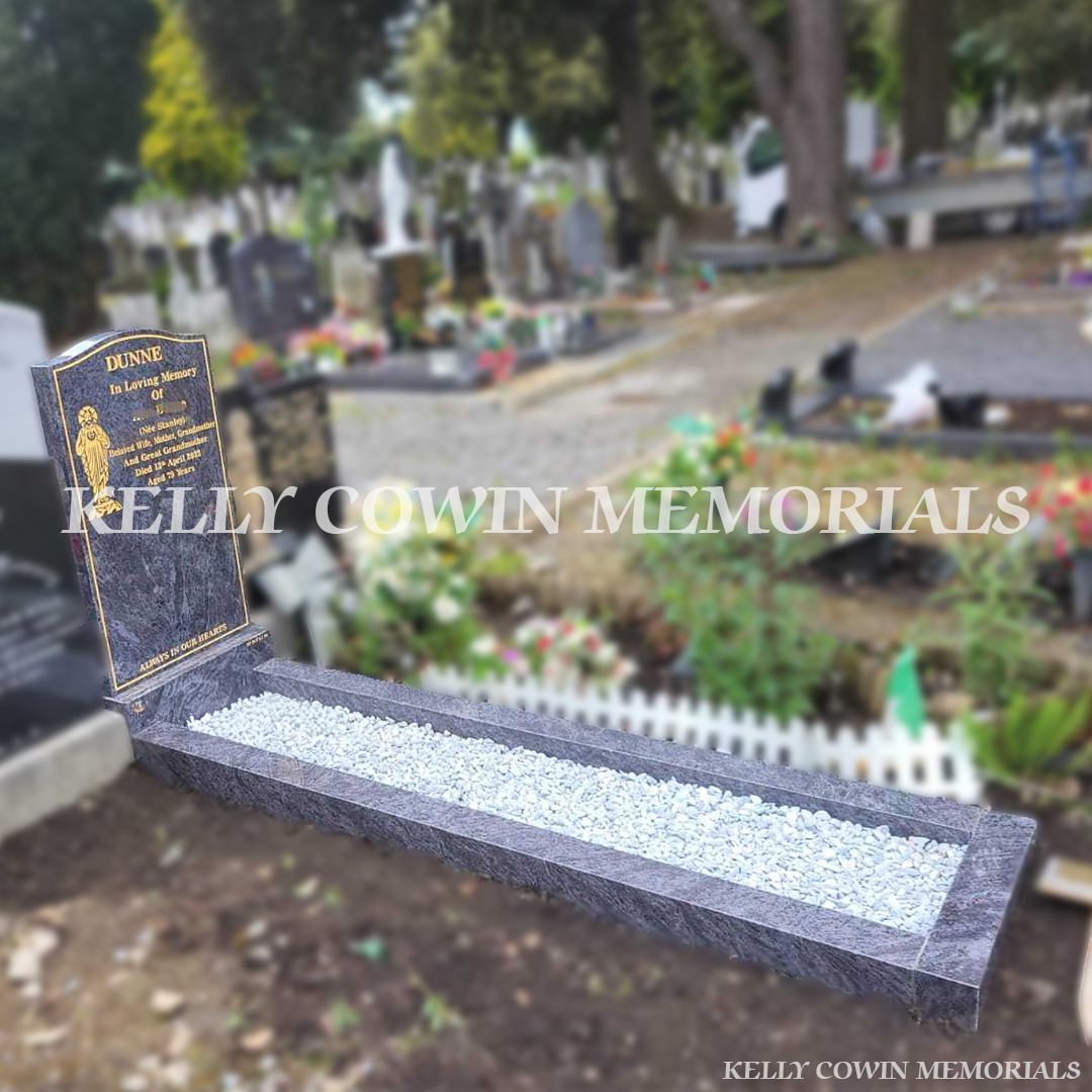 Side view of Blue Lagoon Granite OG-shaped headstone with kerbing showing the polished granite profile and curved OG top – Kelly Cowin Memorials