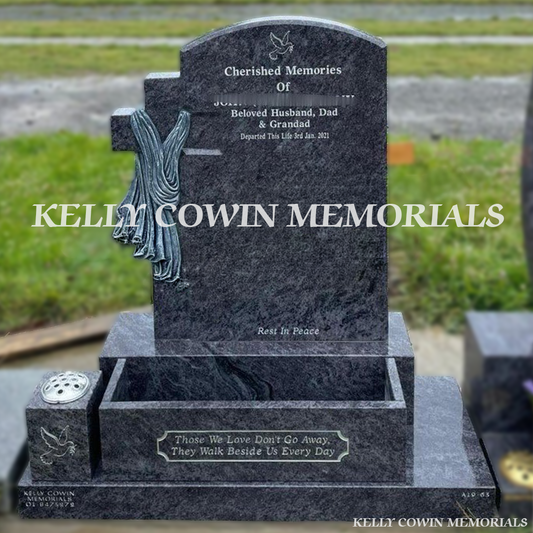 Blue Lagoon polished boulder headstone with carved cross and silver inscription in Shanganagh Cemetery.