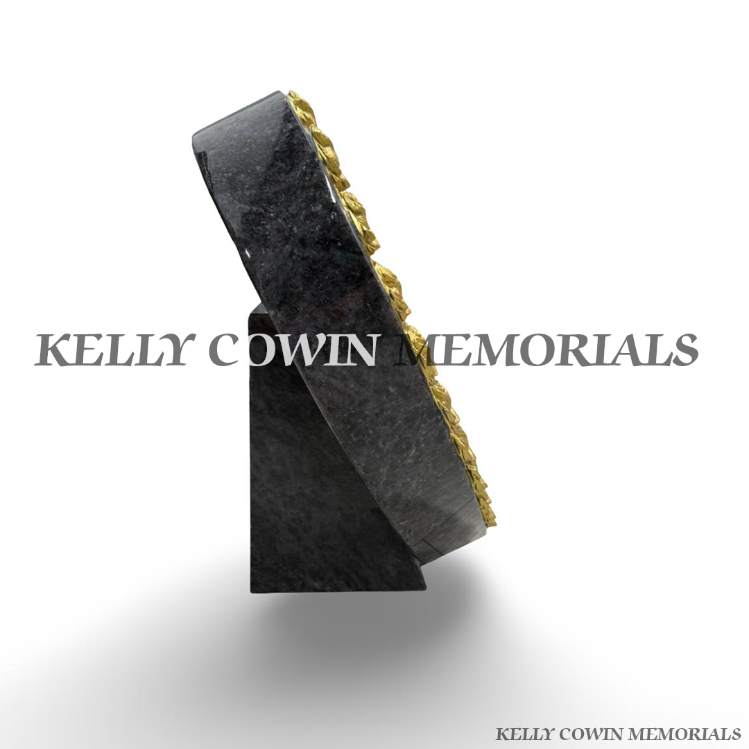 Side view of thick polished Blue Lagoon granite rose carved heart memorial plaque with granite support stand.