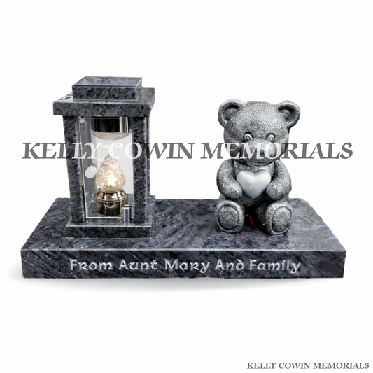Front view of Blue Lagoon solar lantern on plinth with silver engraving and teddy bear statue
