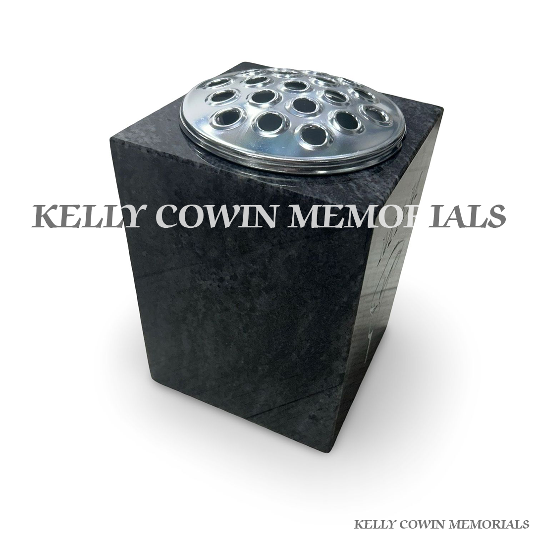 Side view of polished Blue Lagoon granite square vase with silver lid