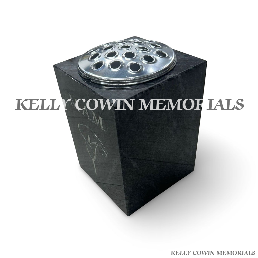 Side view of polished Blue Lagoon granite square vase with silver lid
