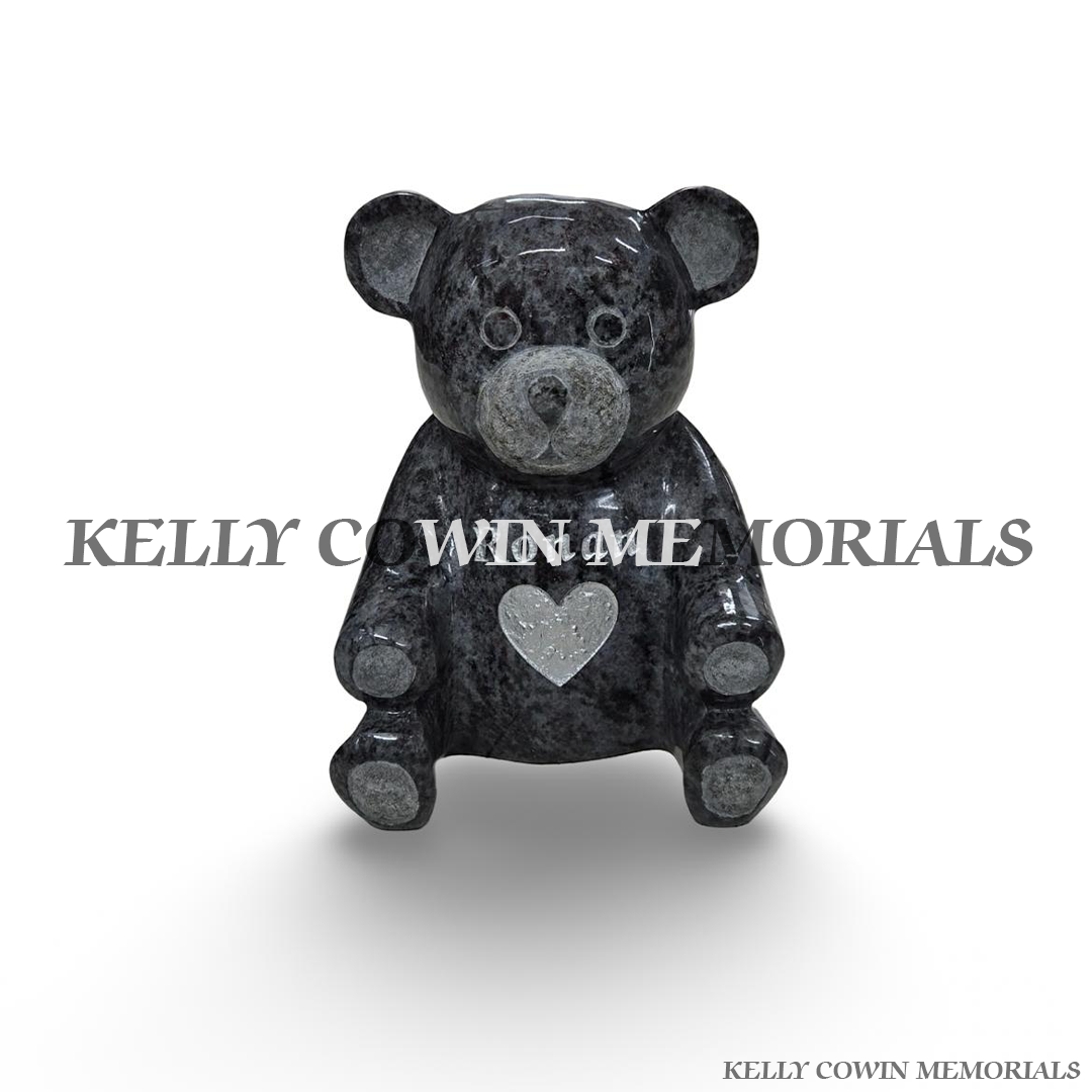 Blue Lagoon polished granite teddy bear memorial ornament featuring carved facial details, rounded ears, seated paws and contrasting silver heart on its chest by Kelly Cowin Memorials.
