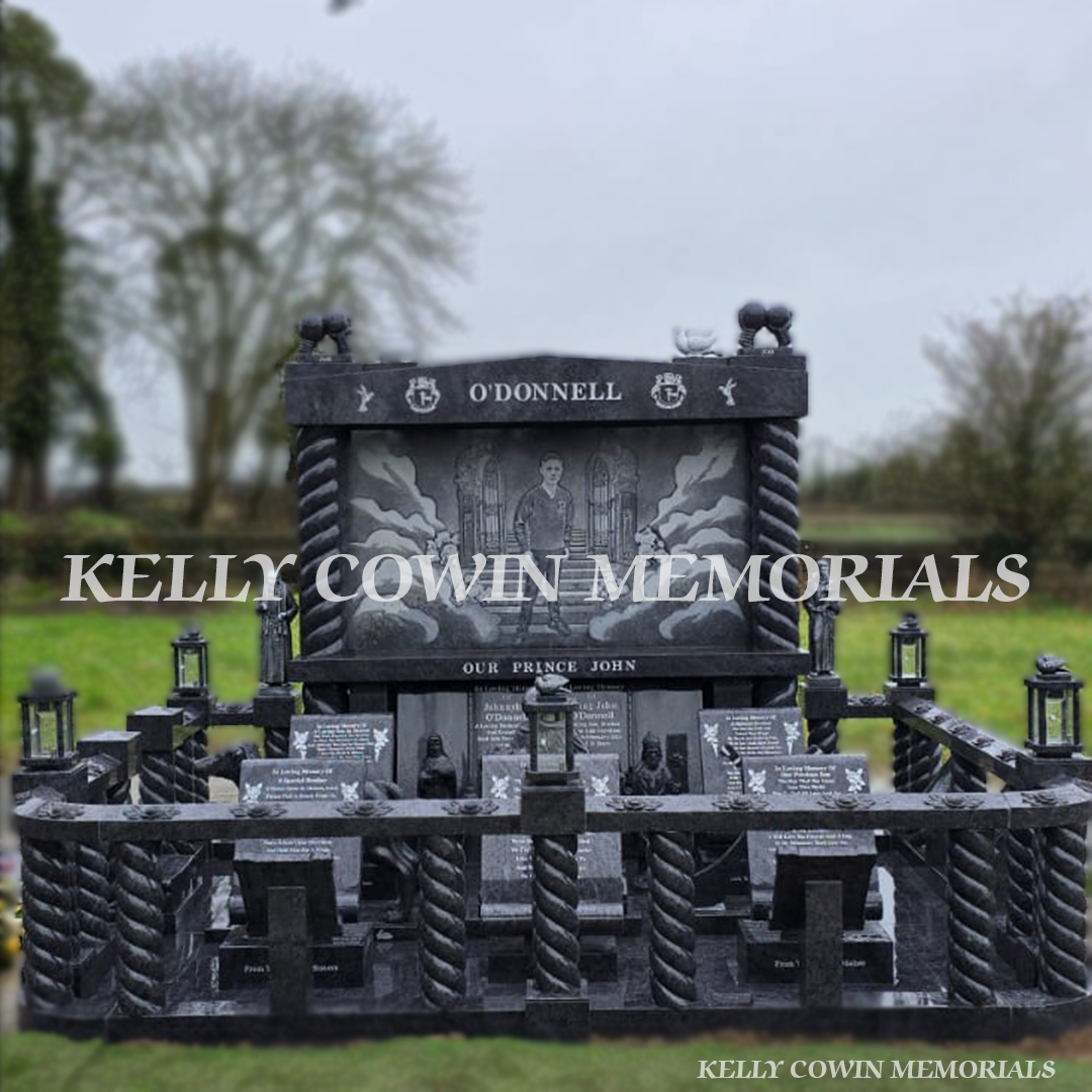 Blue Lagoon Traveller headstone in Limerick with twisted pillars, carved rail and full custom granite statues – Kelly Cowin Memorials