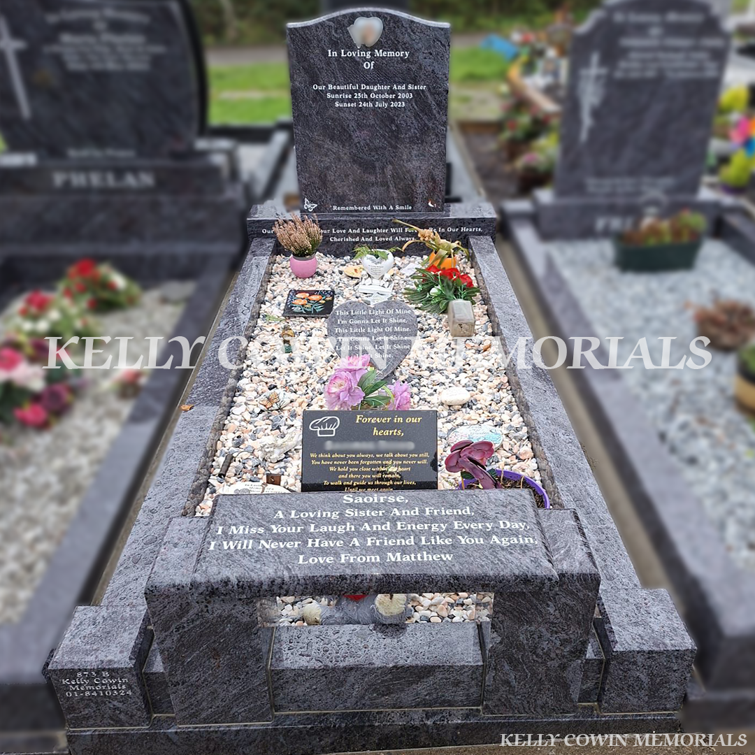 Blue Lagoon granite headstone with full kerb set, white inscription and personalised memorial plaques installed by Kelly Cowin Memorials in Ireland. (dark grey granite)