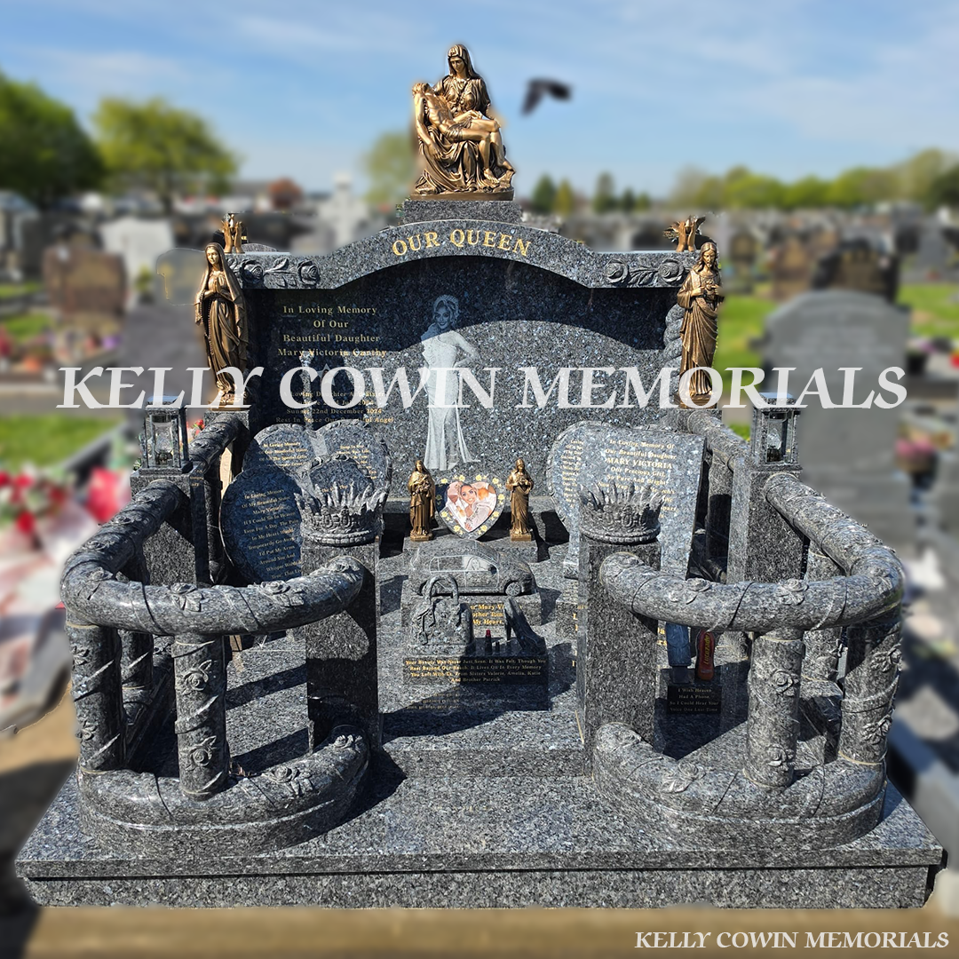 Front view of Blue Pearl custom headstone with gold leaf inscription and statues in Kilkenny