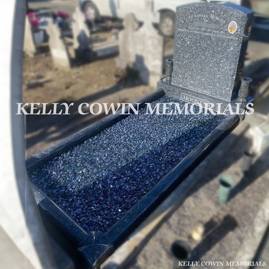Front view of Blue Pearl polished boulder headstone with silver engraving in a Dublin cemetery