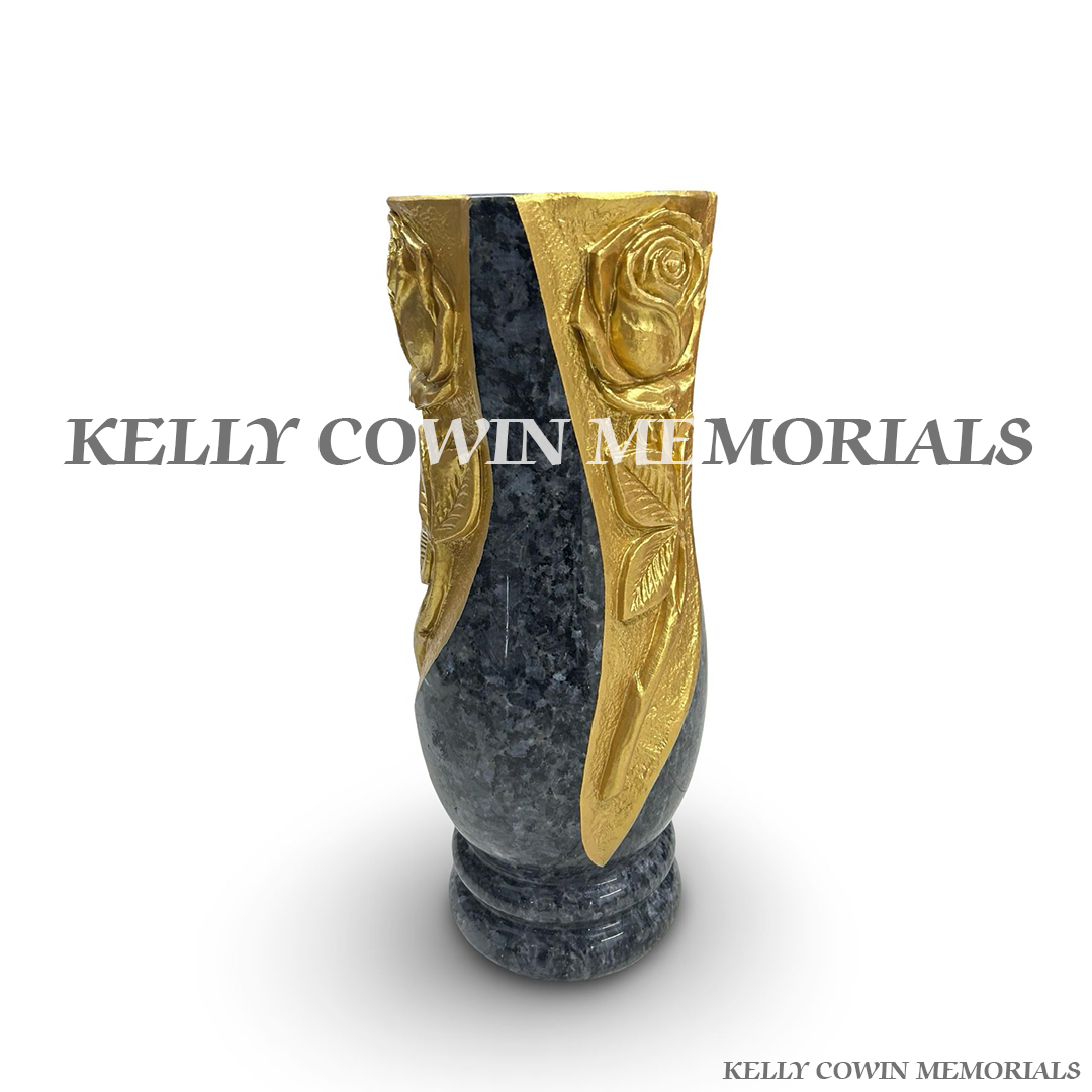 Side view of polished Blue Lagoon granite tall vase with carved rose