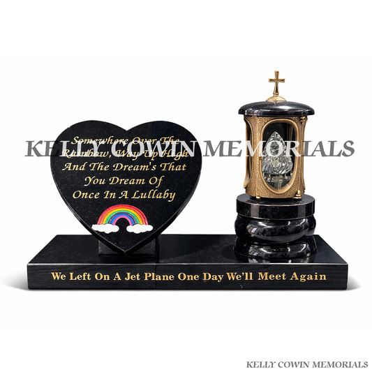 Front view of bronze cross lantern with black granite heart and rainbow engraving