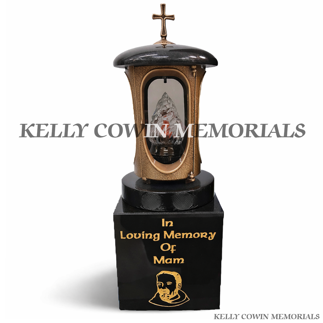Front view of bronze memorial lantern with cross on black granite block and gold inscription