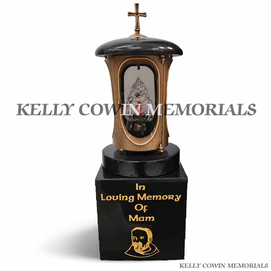 Front view of bronze memorial lantern with cross on black granite block and gold inscription