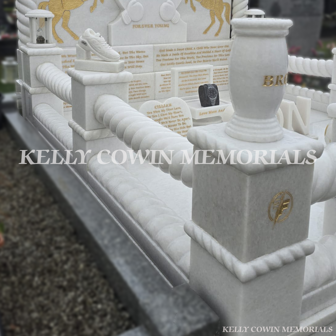 Crystal White marble twisted rail and pillar detail with gold engraved motifs in Mulhuddart Cemetery Dublin
