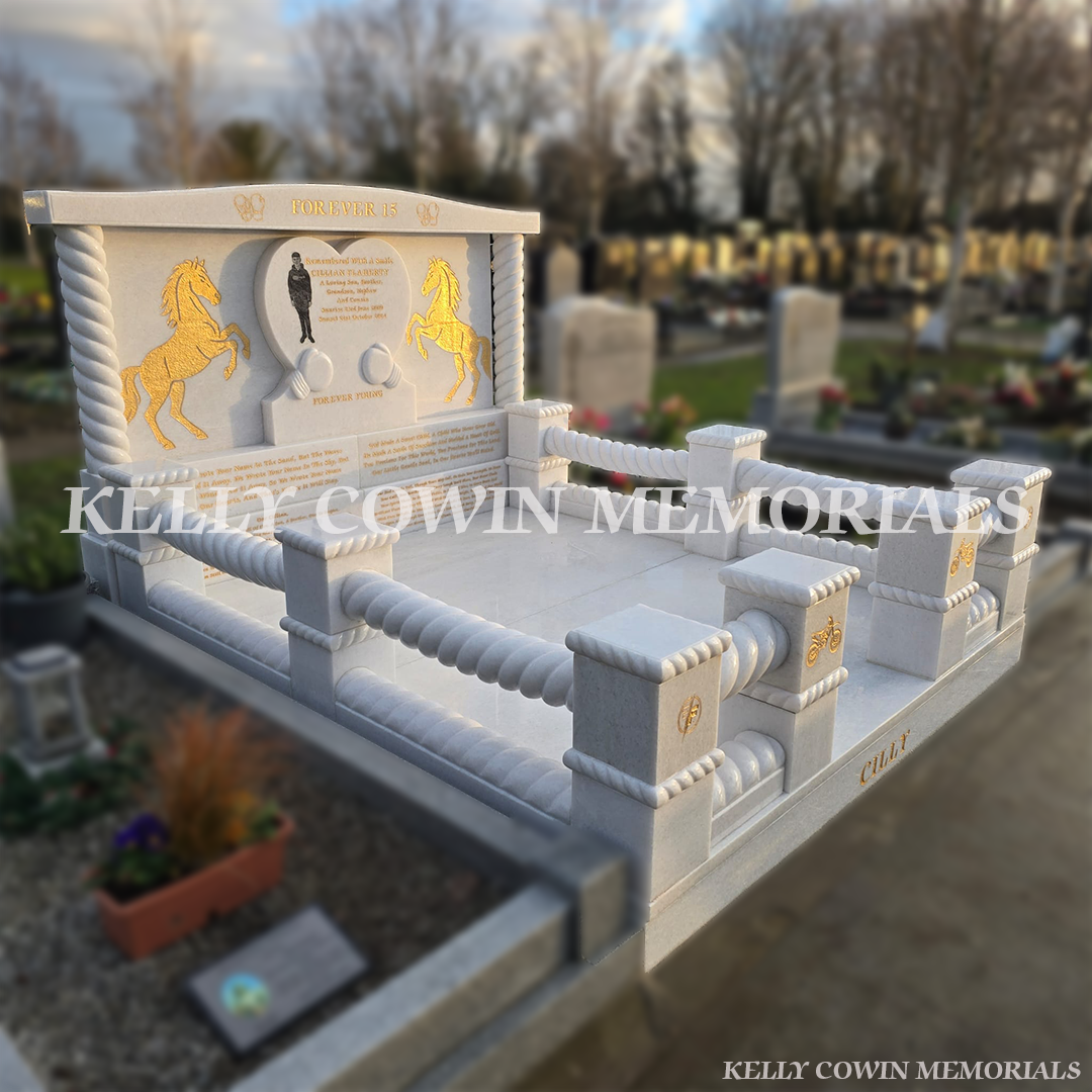 side view of a Crystal White marble custom children’s headstone with heart design, gold leaf engraving and full kerbing in Mulhuddart Cemetery Dublin