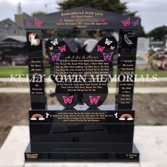 Black granite butterfly children’s headstone with a cap and pillars and coloured inscription in Balgriffin Cemetery Dublin