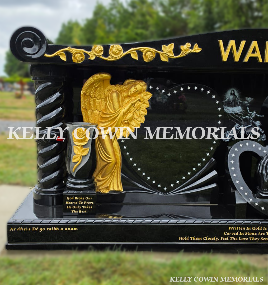 Gold rose-carved angel beside heart-shaped inscription panel on bespoke black granite headstone in Dublin.