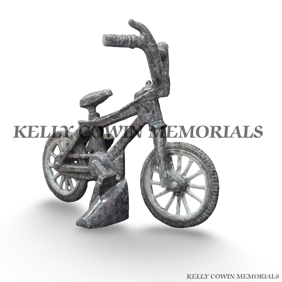 Front view of Blue Lagoon granite bicycle memorial showing handlebars, front wheel and handcrafted granite detailing.