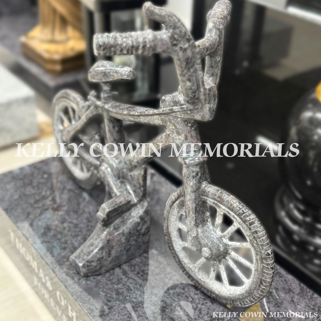 Close-up of Blue Lagoon granite bike showing detailed handlebars, wheel, frame and polished finish.