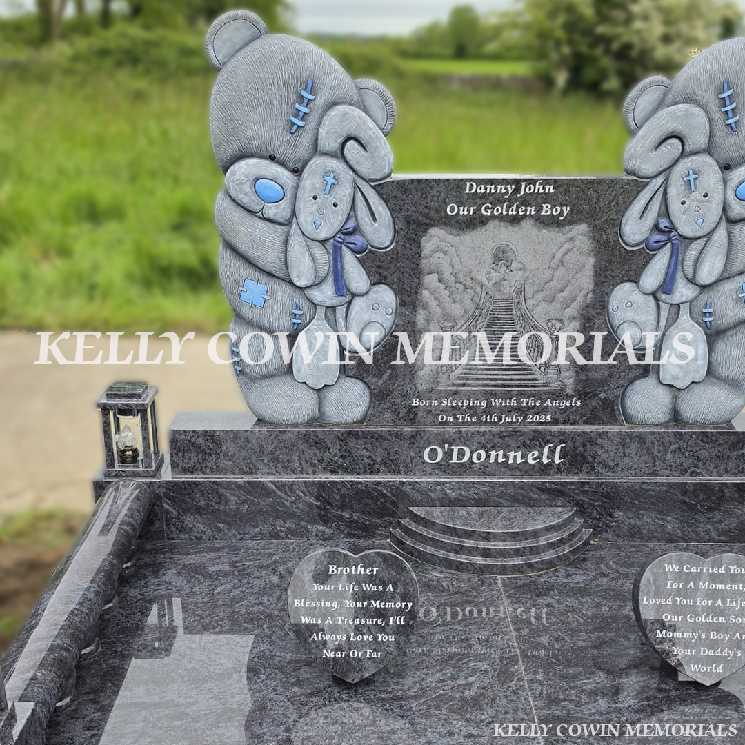 Front view of Blue Lagoon child headstone with heart memorial accessories and granite surround