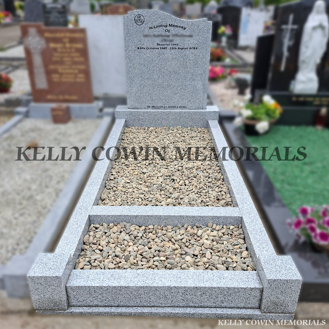 Grey granite custom headstone with granite kerbing, mixed pebble garden border, granite corner posts and black inscription in St. Peter and Paul's Cemetery, Balbriggan.