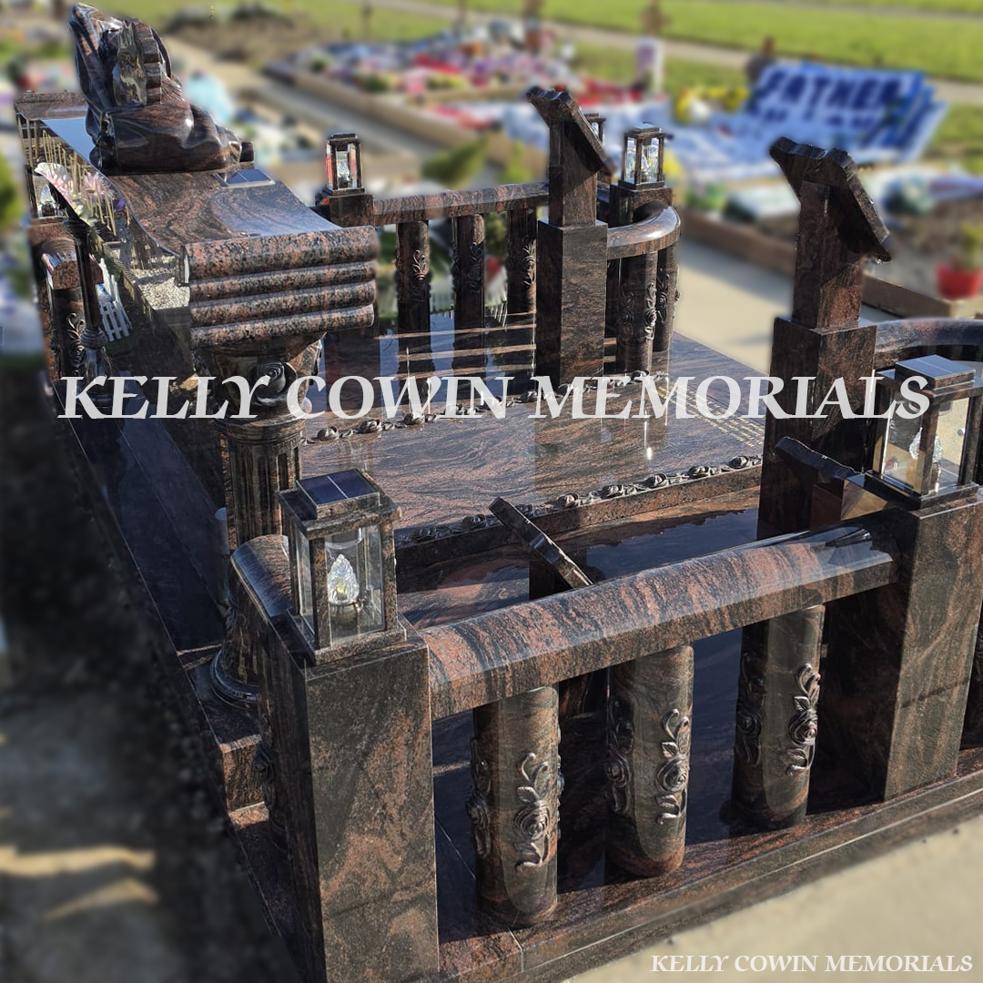 Side view of Pandora granite memorial with railings, pillars and statues