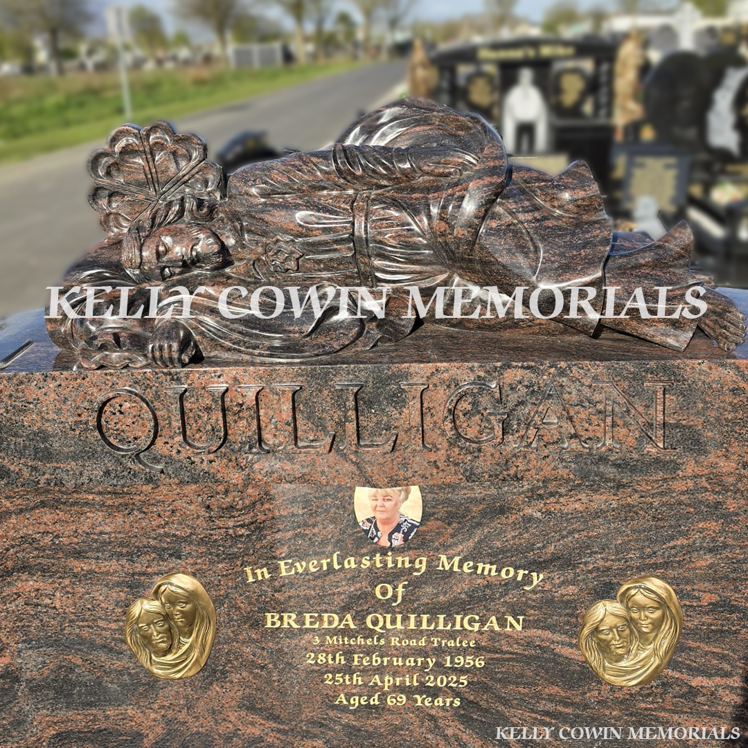 Close-up of carved roses and 23.5ct gold leaf lettering on Pandora granite headstone