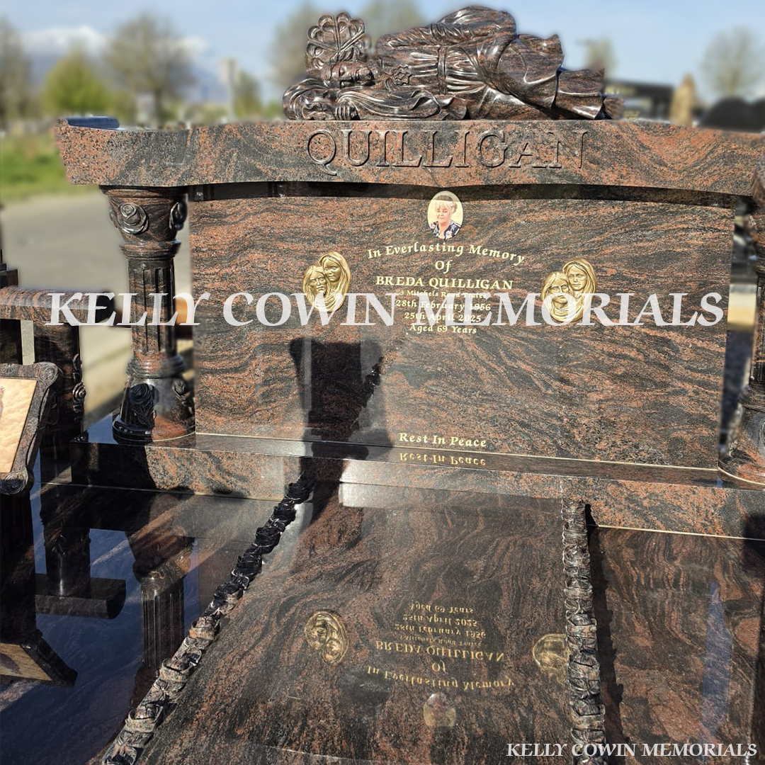 Close-up of carved roses and 23.5ct gold leaf lettering on Pandora granite headstone