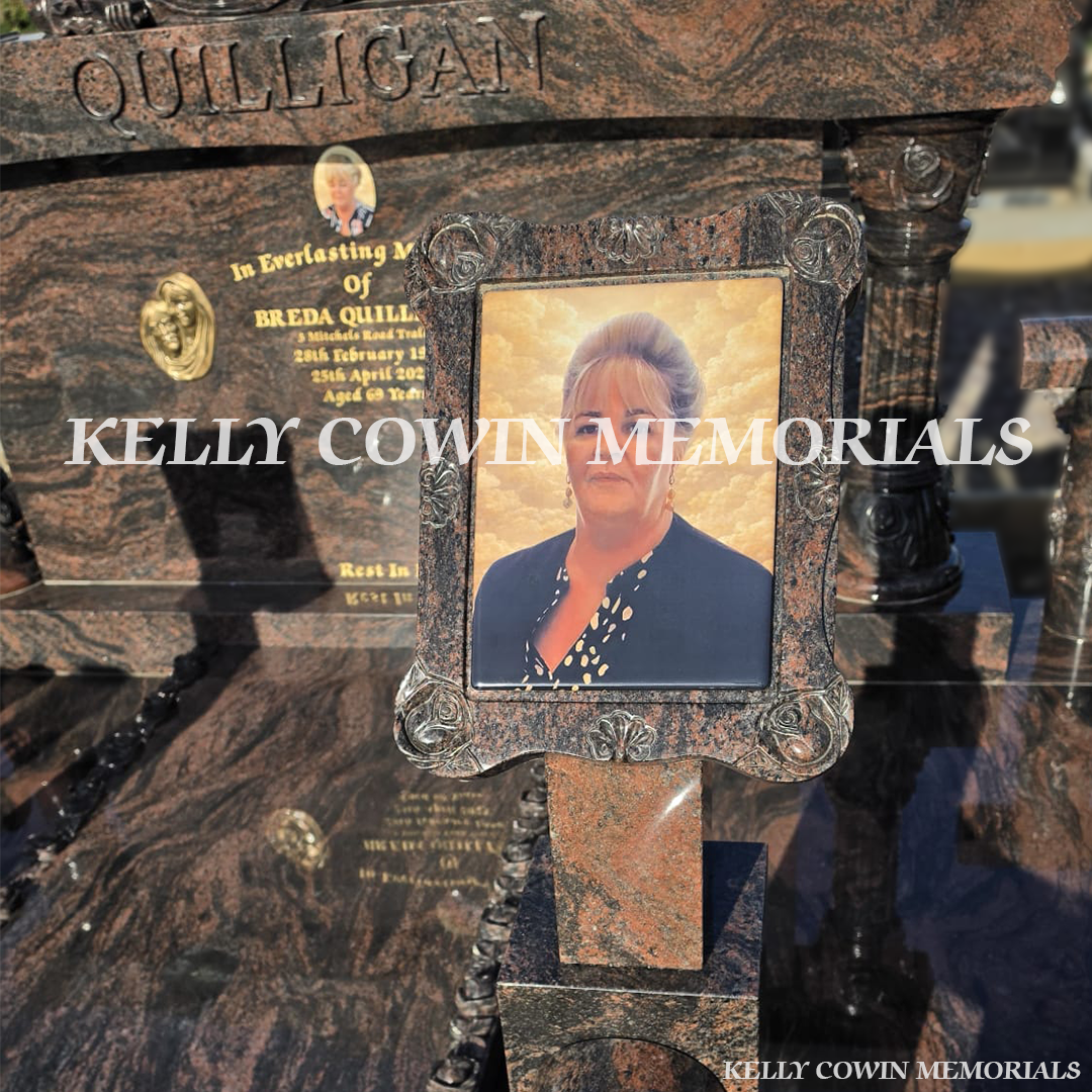 Close-up of carved roses and 23.5ct gold leaf lettering on Pandora granite headstone