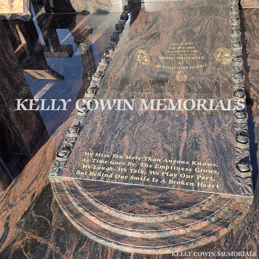 Close-up of carved roses and 23.5ct gold leaf lettering on Pandora granite headstone
