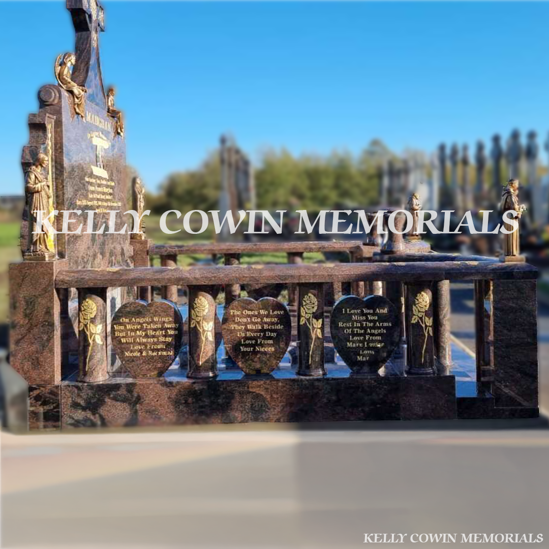 Side view showing granite rail surround, steps, bronze statues and lanterns in Glasnevin Cemetery Dublin