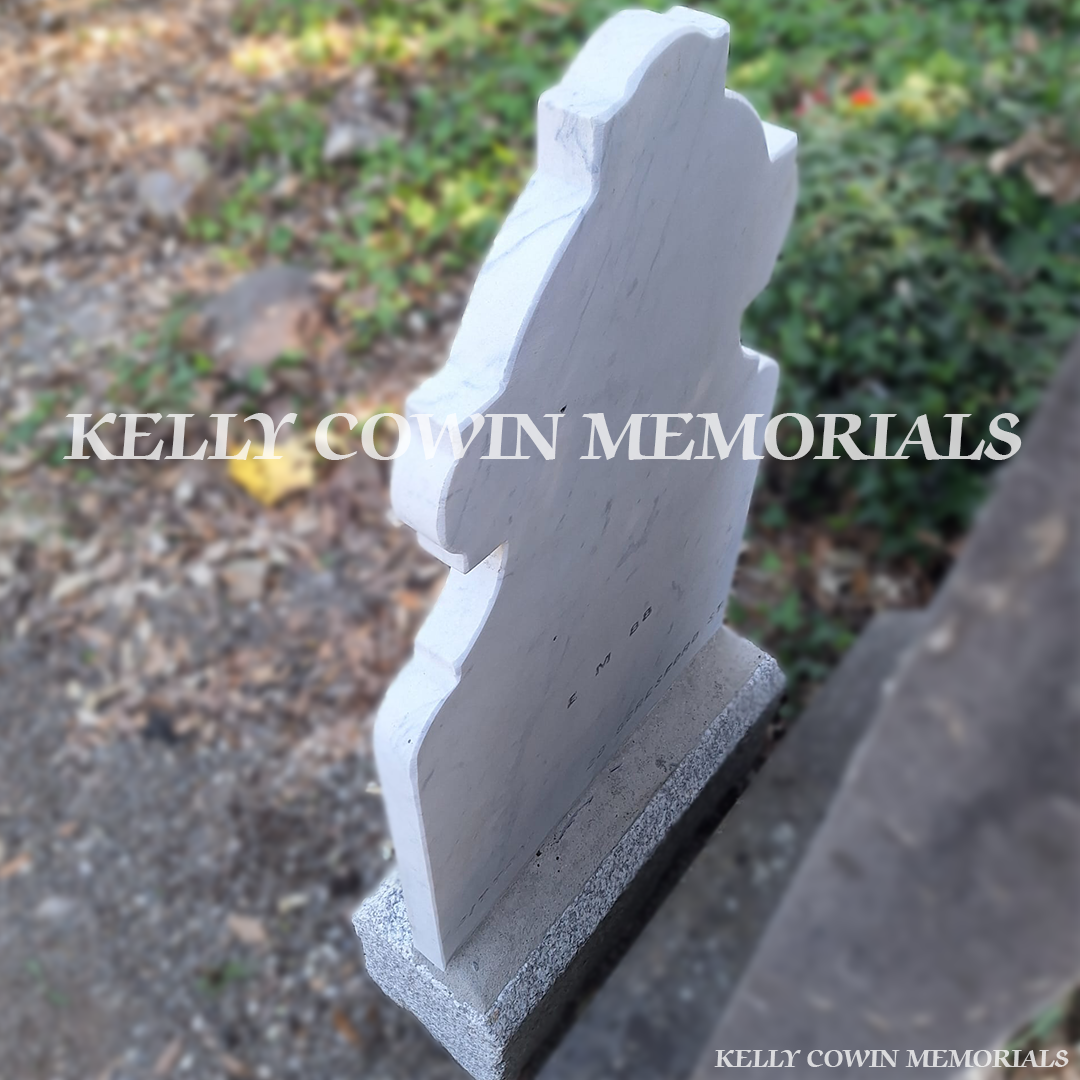 After renovation of restored white marble memorial and limestone base