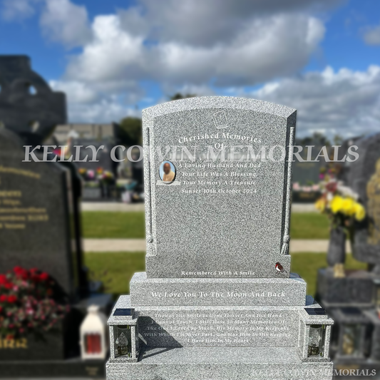 Grey granite polished boulder headstone with base, plinth, solar lanterns and oval ceramic photo in Balgriffin Cemetery, Dublin