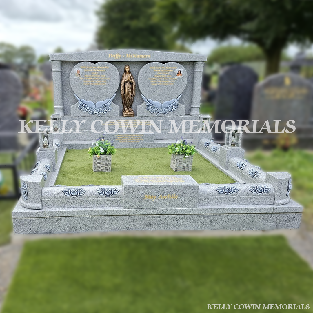 Grey granite double heart Traveller headstone with bronze Our Lady statue, rose carved kerbing and gold leaf inscription in Mount St Oliver Cemetery, Limerick