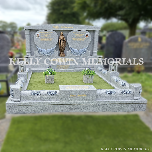 Grey granite double heart Traveller headstone with bronze Our Lady statue, rose carved kerbing and gold leaf inscription in Mount St Oliver Cemetery, Limerick