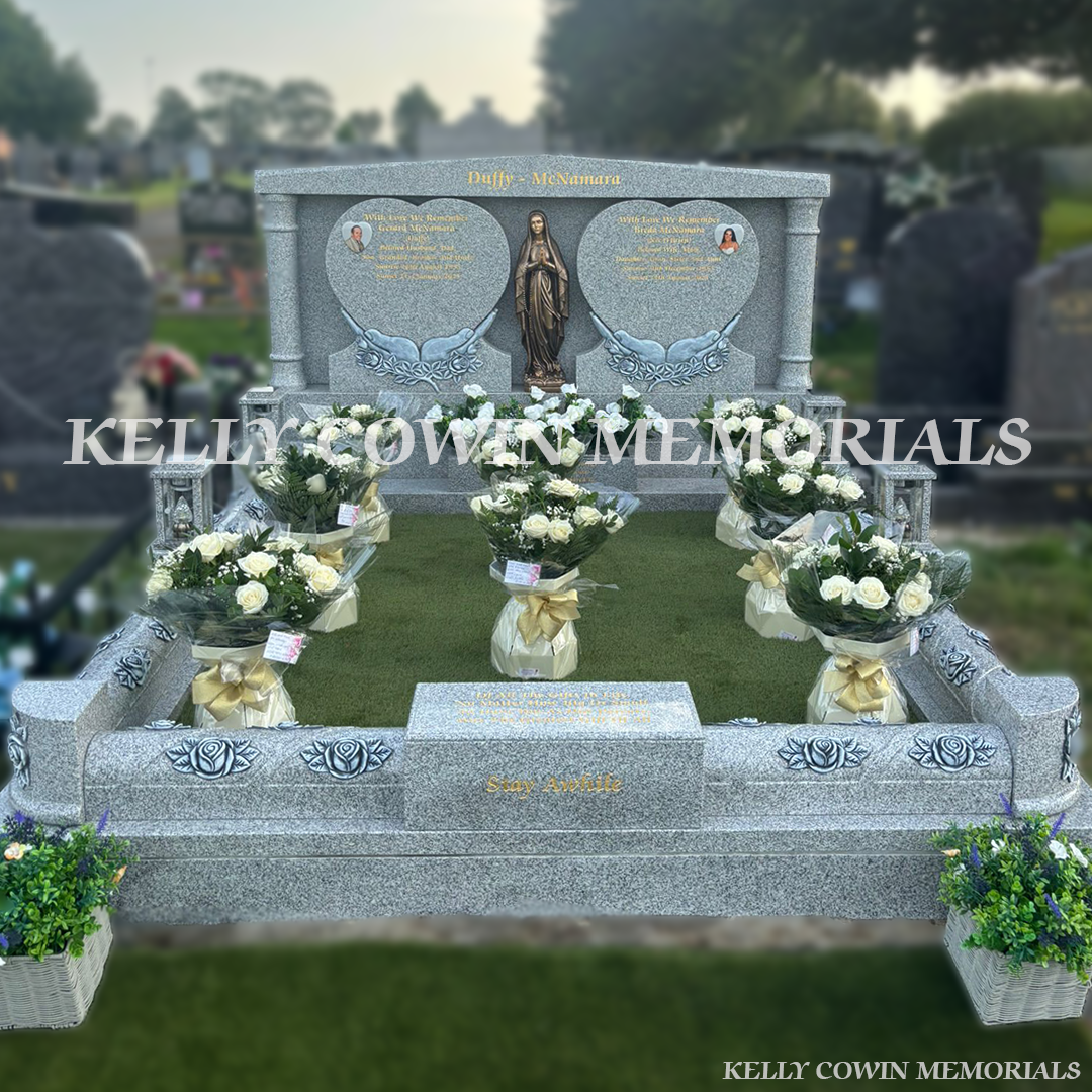 Grey granite double heart Traveller headstone with bronze Our Lady statue, rose carved kerbing and gold leaf inscription in Mount St Oliver Cemetery, Limerick