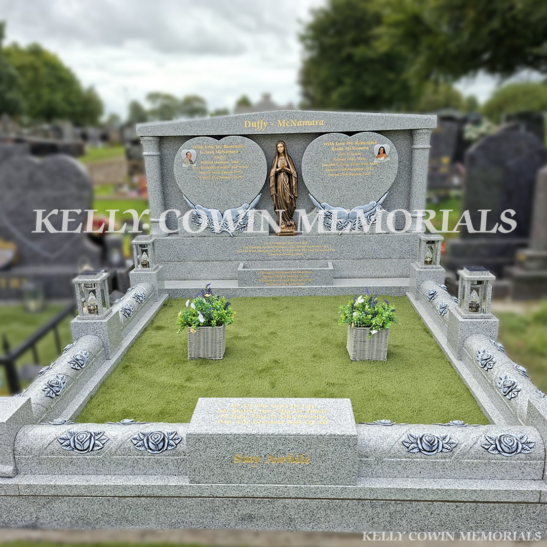 Grey granite double heart Traveller headstone with bronze Our Lady statue, rose carved kerbing and gold leaf inscription in Mount St Oliver Cemetery, Limerick