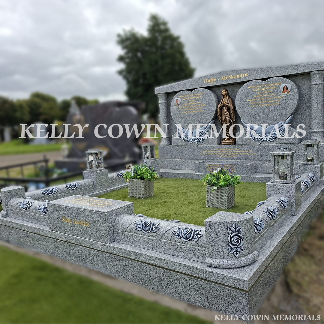 Grey granite double heart Traveller headstone with bronze Our Lady statue, rose carved kerbing and gold leaf inscription in Mount St Oliver Cemetery, Limerick