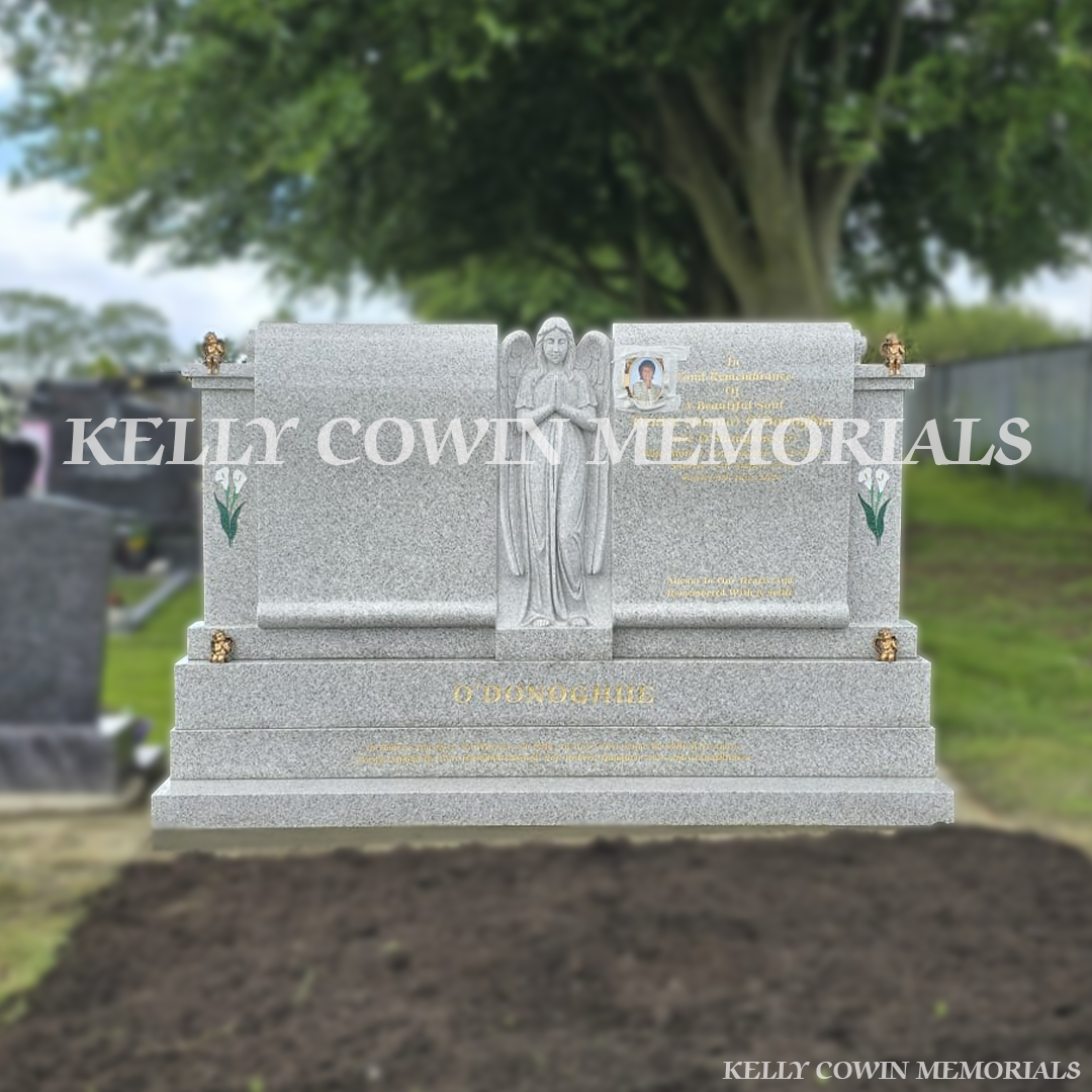 Pearl white double scroll Traveller headstone with carved angel, bronze angels and gold leaf inscription in Mount St Oliver’s Cemetery, Limerick