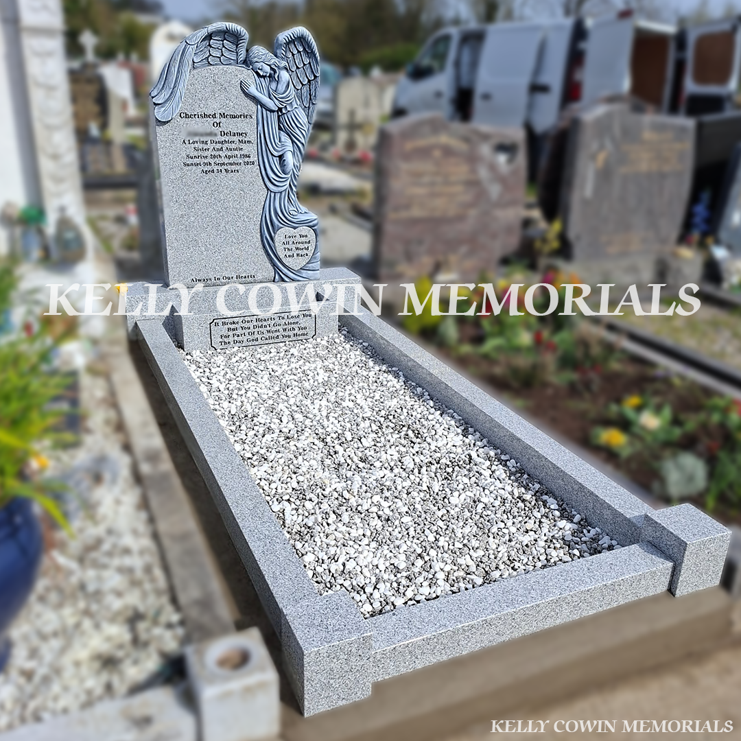 Side view of grey granite memorial with kerbing and chippings